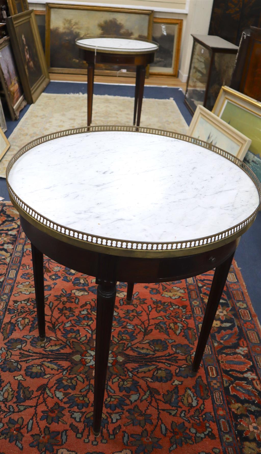 A pair of French style mahogany occasional tables with brass galleried marble tops, 65cm diameter, 75cm high